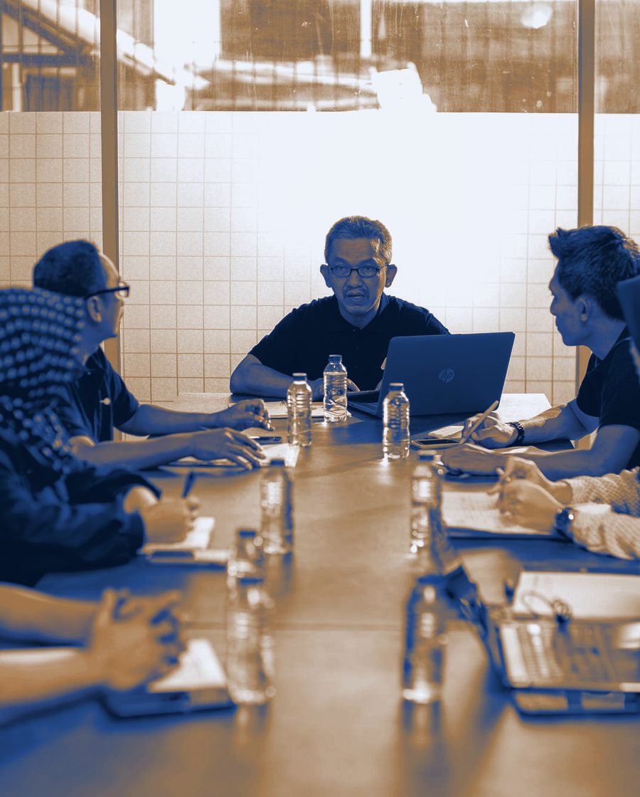 A client meeting in progress around a boardroom table